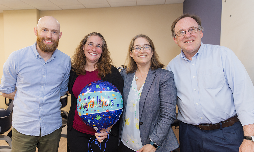 Alison Castellano, the 2024 recipient of the ǿ޴ý Teaching Excellence Award, stands proudly with previous Teaching Excellence Awardees who eagerly pass her the torch of honor! (L to R) Mike Rust (2022), Alison Castellano (2024), Hillary Bucs (2021), and Tim Vercellotti (2023).