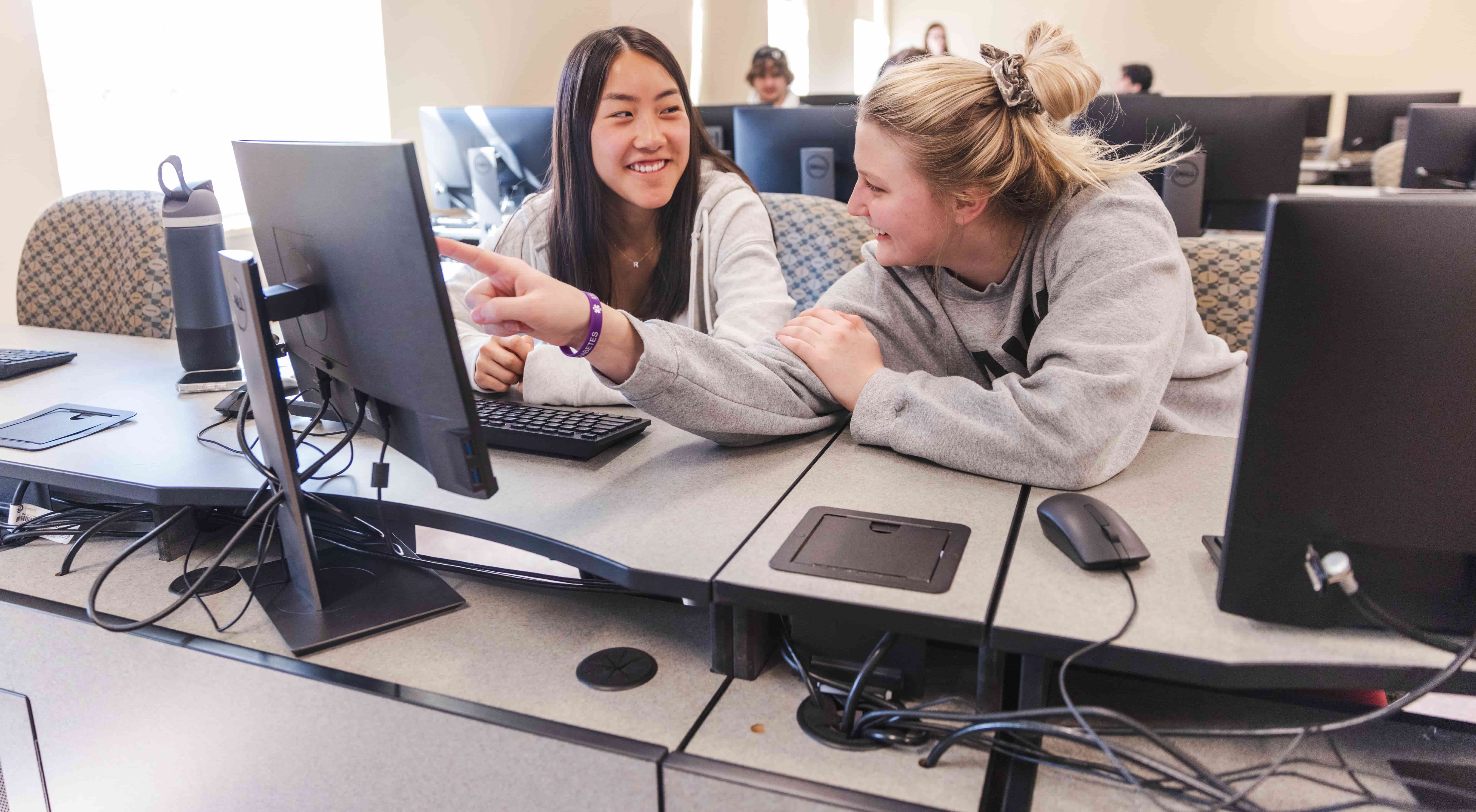 Two female students working at computer