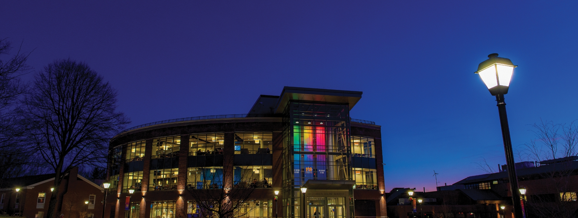 Nighttime view of the University Commons with centennial banners